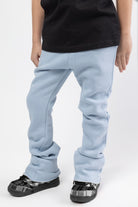 Carolina blue Stacked jogger for kids with flat draw cord, featuring two functional slash pockets at front and one patch pocket at back.