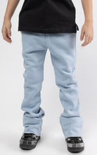Carolina blue Stacked jogger for kids with flat draw cord, featuring two functional slash pockets at front and one patch pocket at back.