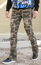 Camo super stacked jeans featuring an extra-long inseam and flared leg opening with distressing, stone washing and frays.