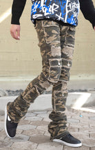 Camo super stacked jeans featuring an extra-long inseam and flared leg opening with distressing, stone washing and frays.