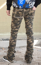 Camo super stacked jeans featuring an extra-long inseam and flared leg opening with distressing, stone washing and frays.