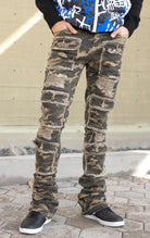 Camo super stacked jeans featuring an extra-long inseam and flared leg opening with distressing, stone washing and frays.