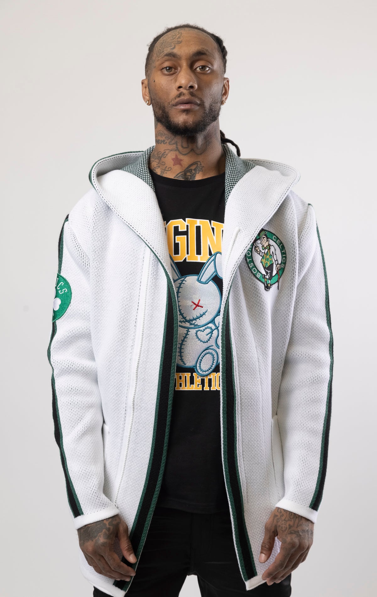 Upgrade your game day look with this Boston Celtics Cardigan Sweater. This cozy jacket is designed with a stylish three-quarter length and boasts bold team branding on the front, back, and sleeve. Complete with a full-zip closure, attached hood, and front pockets, this knit sweater offers both comfort and style.