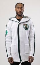 Upgrade your game day look with this Boston Celtics Cardigan Sweater. This cozy jacket is designed with a stylish three-quarter length and boasts bold team branding on the front, back, and sleeve. Complete with a full-zip closure, attached hood, and front pockets, this knit sweater offers both comfort and style.