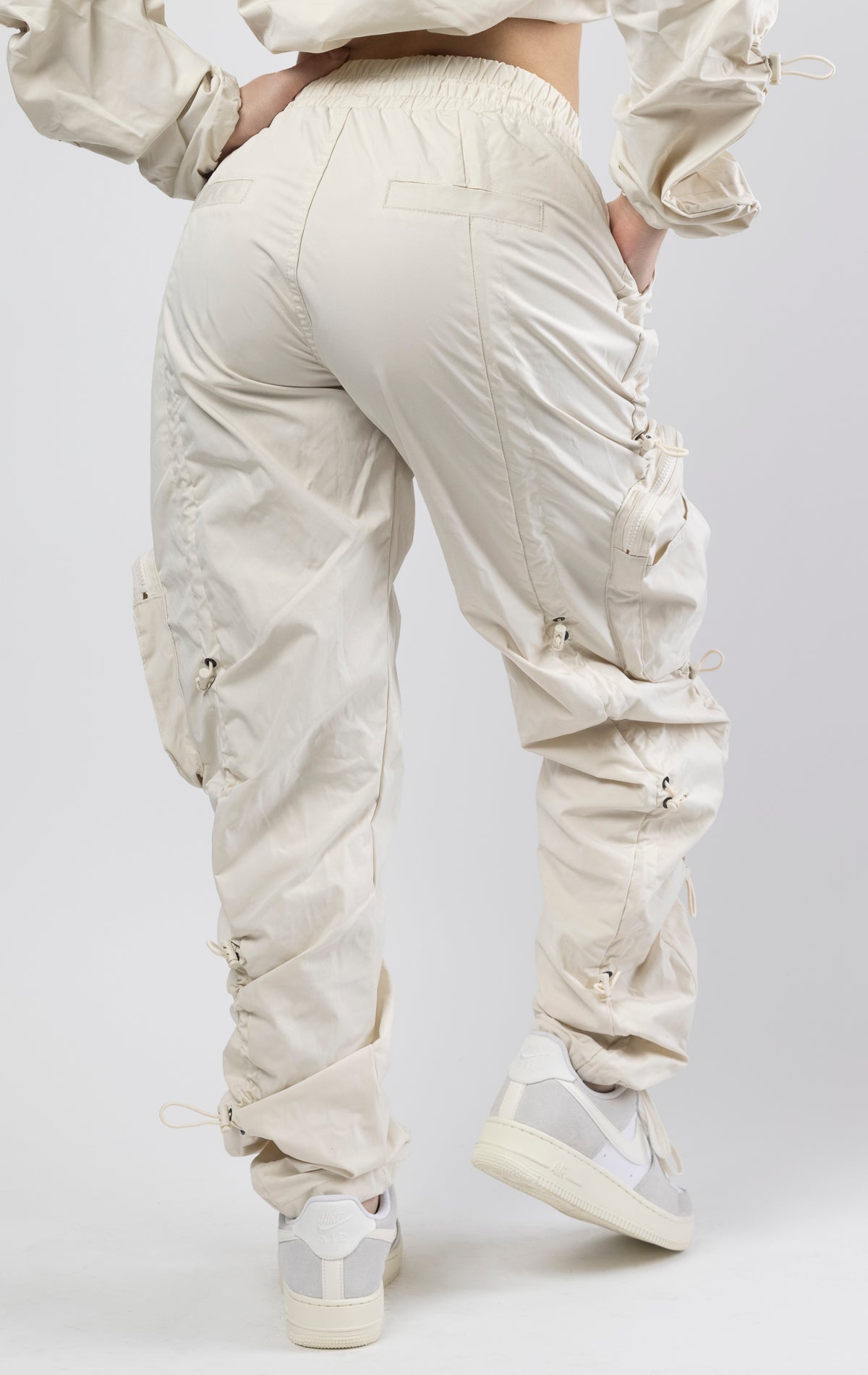 Oatmeal coral multi-bungee jogger featuring a Brook fit, snap buttons, an adjustable waist and wide pockets.