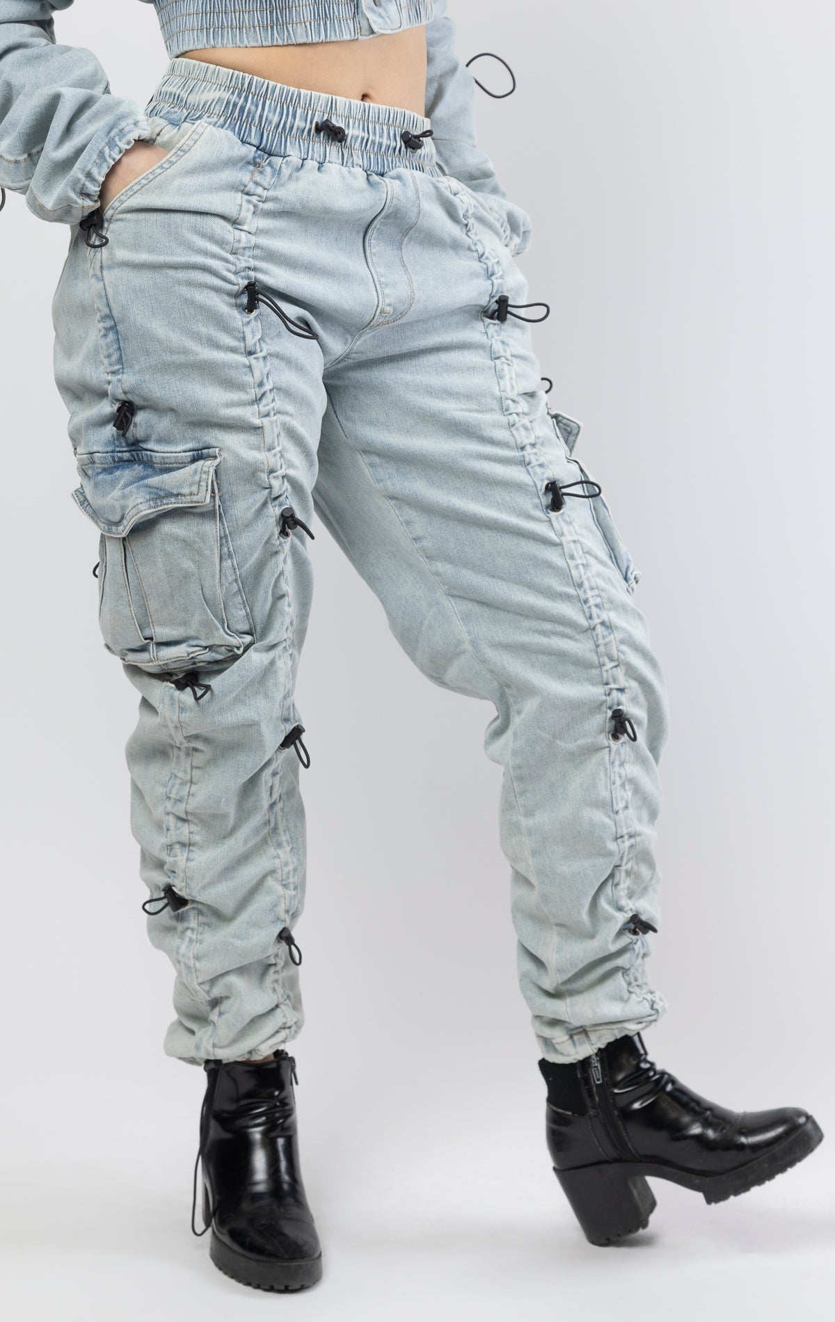 multi-bungee denim jogger features an adjustable waist and wide pockets