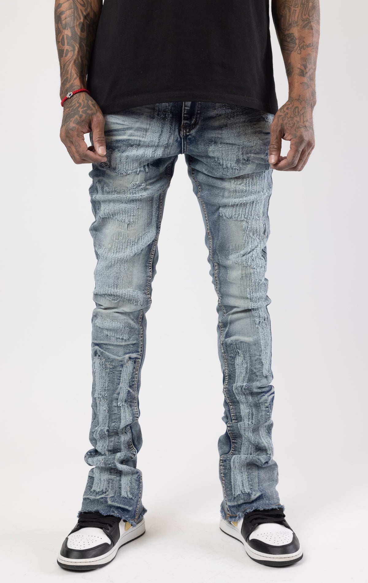 Distressed denim flared jeans with a stacked, skinny fit.