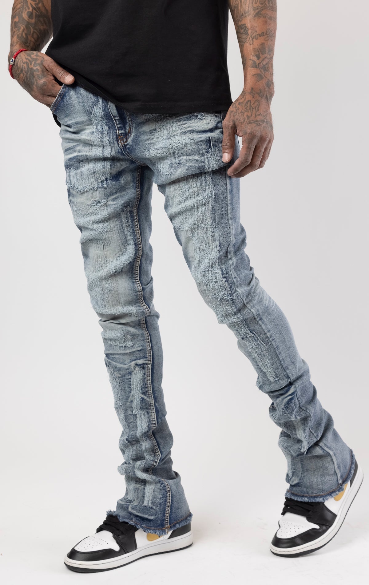 Distressed denim flared jeans with a stacked, skinny fit.