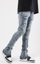 Distressed denim flared jeans with a stacked, skinny fit.