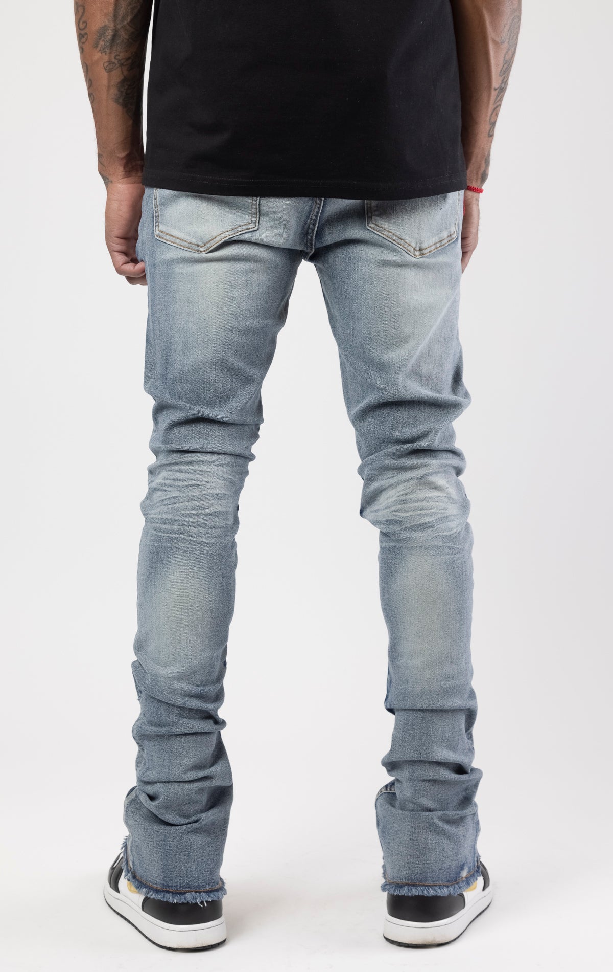 Distressed denim flared jeans with a stacked, skinny fit.
