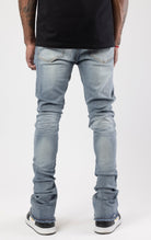 Distressed denim flared jeans with a stacked, skinny fit.