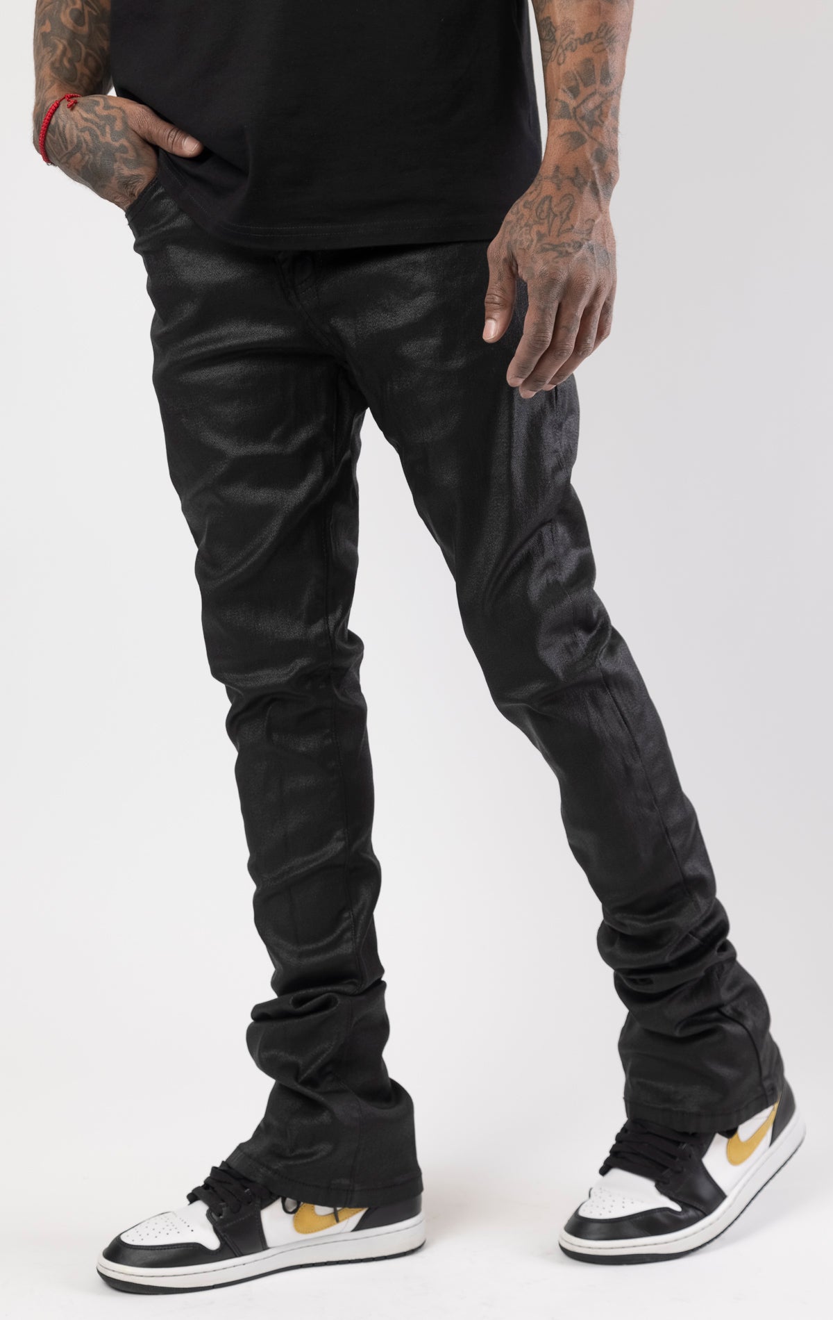 Black Glossy denim with a regular rise, flared stacked jeans