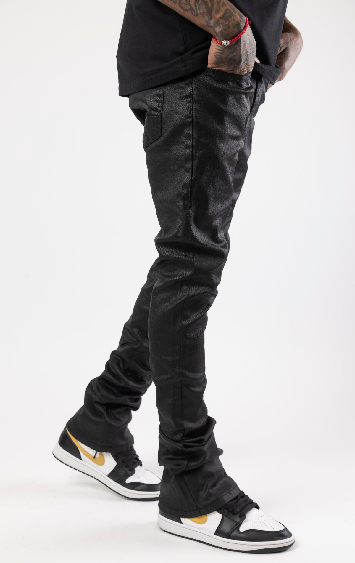 Black Glossy denim with a regular rise, flared stacked jeans