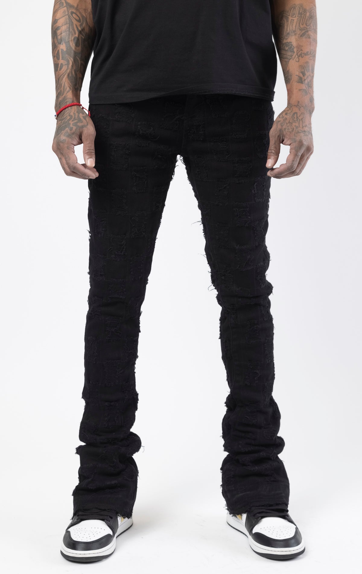 Black stacked flare jeans with distressed design