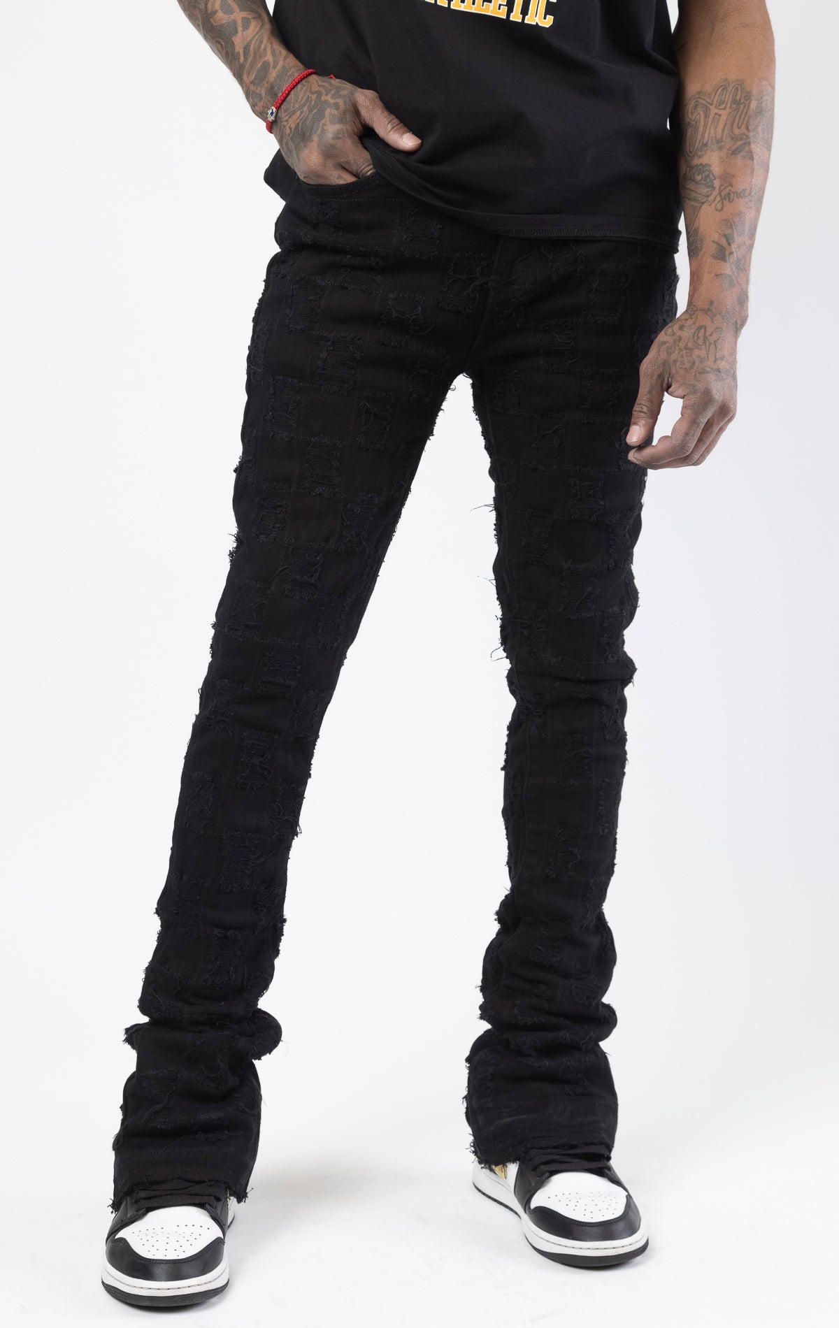 Black stacked flare jeans with distressed design