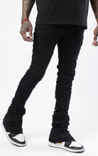 Black stacked flare jeans with distressed design