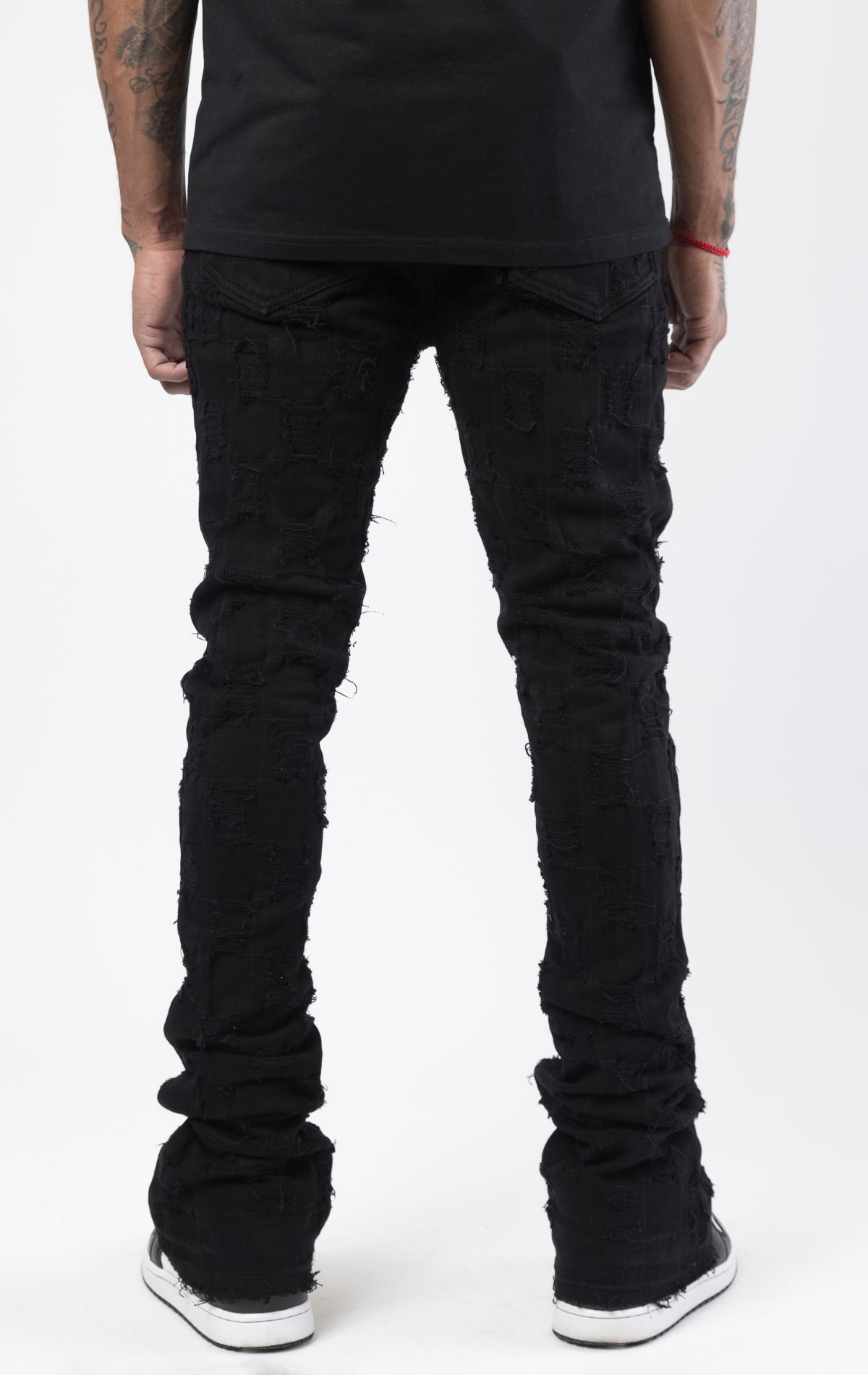 Black stacked flare jeans with distressed design