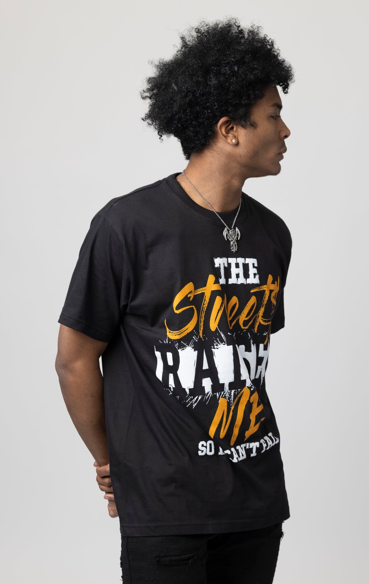 Oversized T-shirt with ribbed crew neck and a "The Streets Raised Me" printed design on the front.