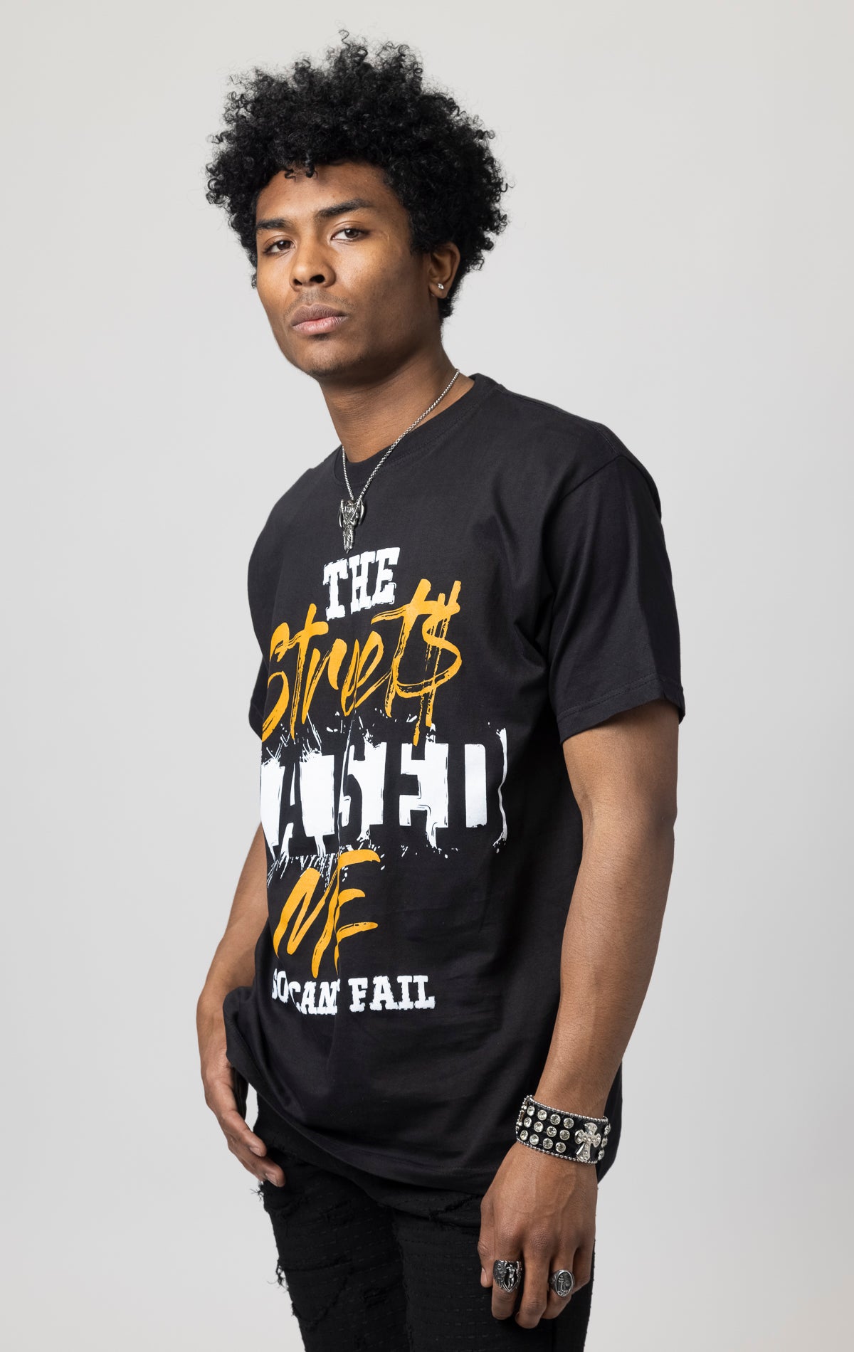 Oversized T-shirt with ribbed crew neck and a "The Streets Raised Me" printed design on the front.