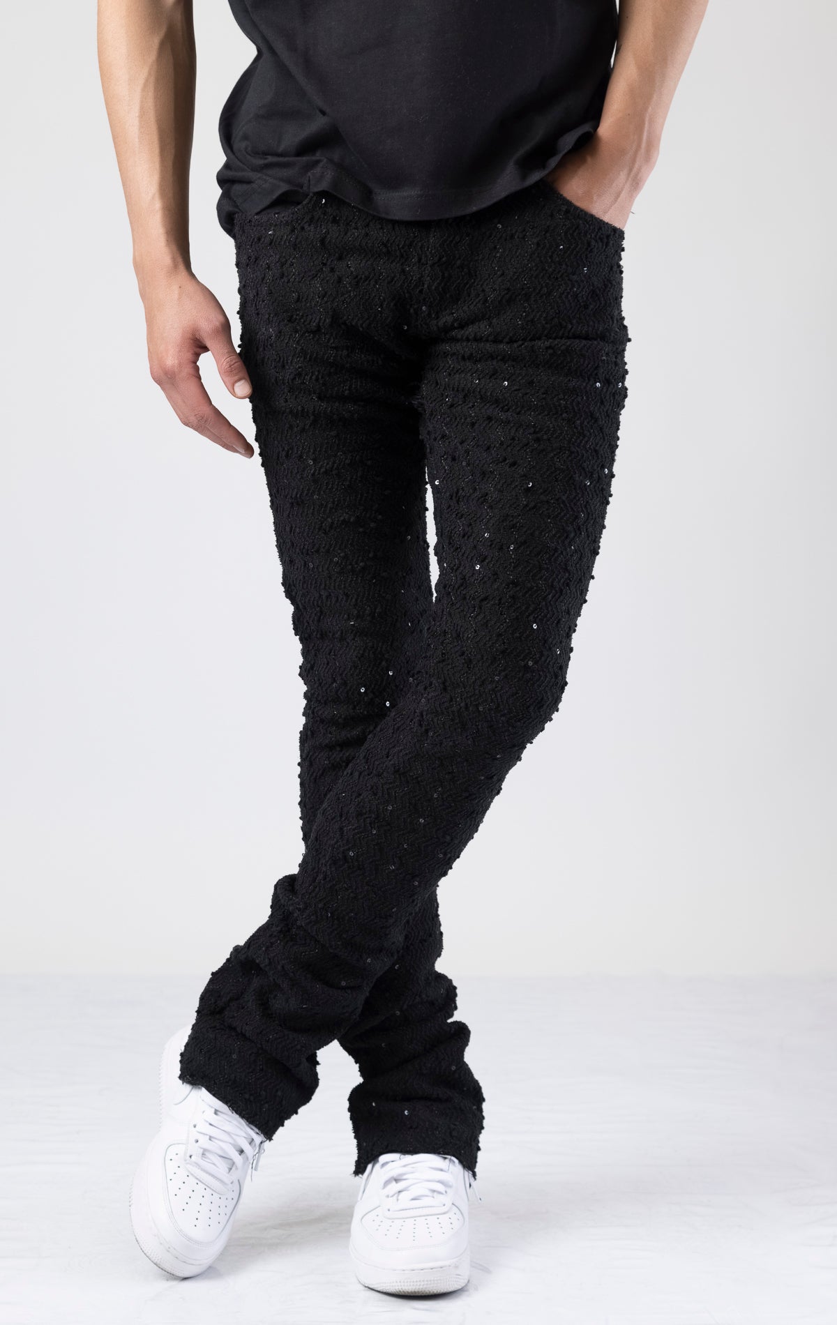 Black embellished stacked flared jeans in black.