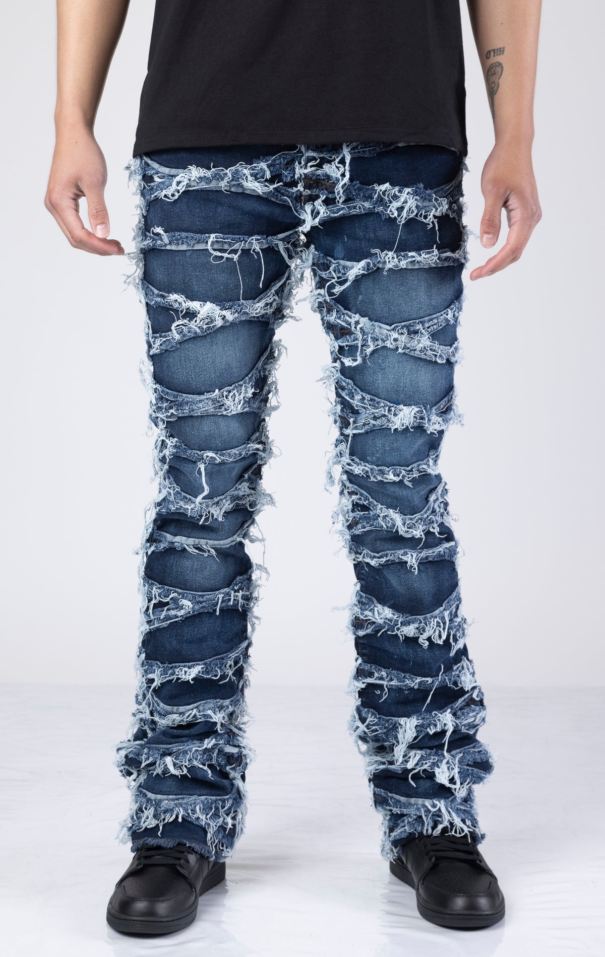 Blue  jeans with frayed detailing at the hems for a distressed look. Made with stretch denim for a comfortable fit. 98% cotton, 2% spandex.