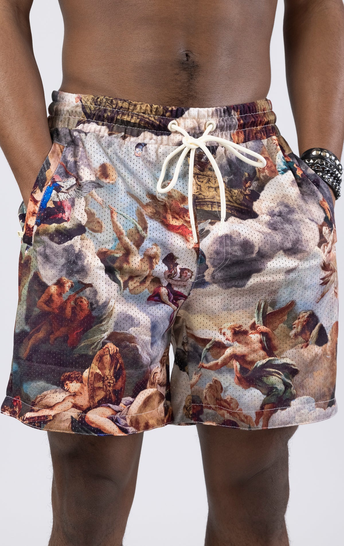 Creme Mesh shorts with an all-over print, zipper side pockets, and a drawstring waist