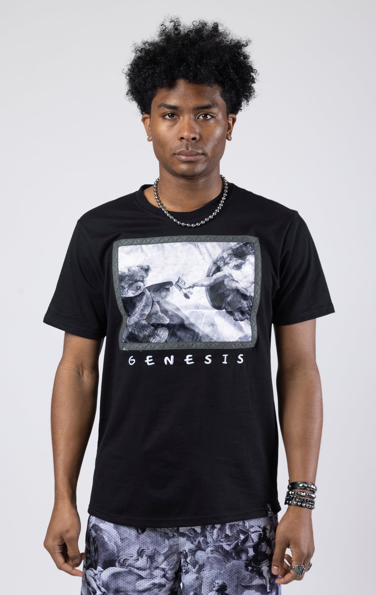 A crew neck graphic t-shirt with a Genesis design, available in creme and black.