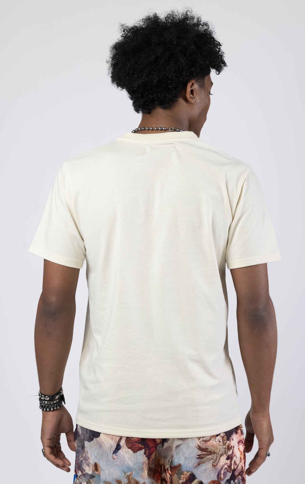A crew neck graphic t-shirt with a Genesis design, available in creme and black.