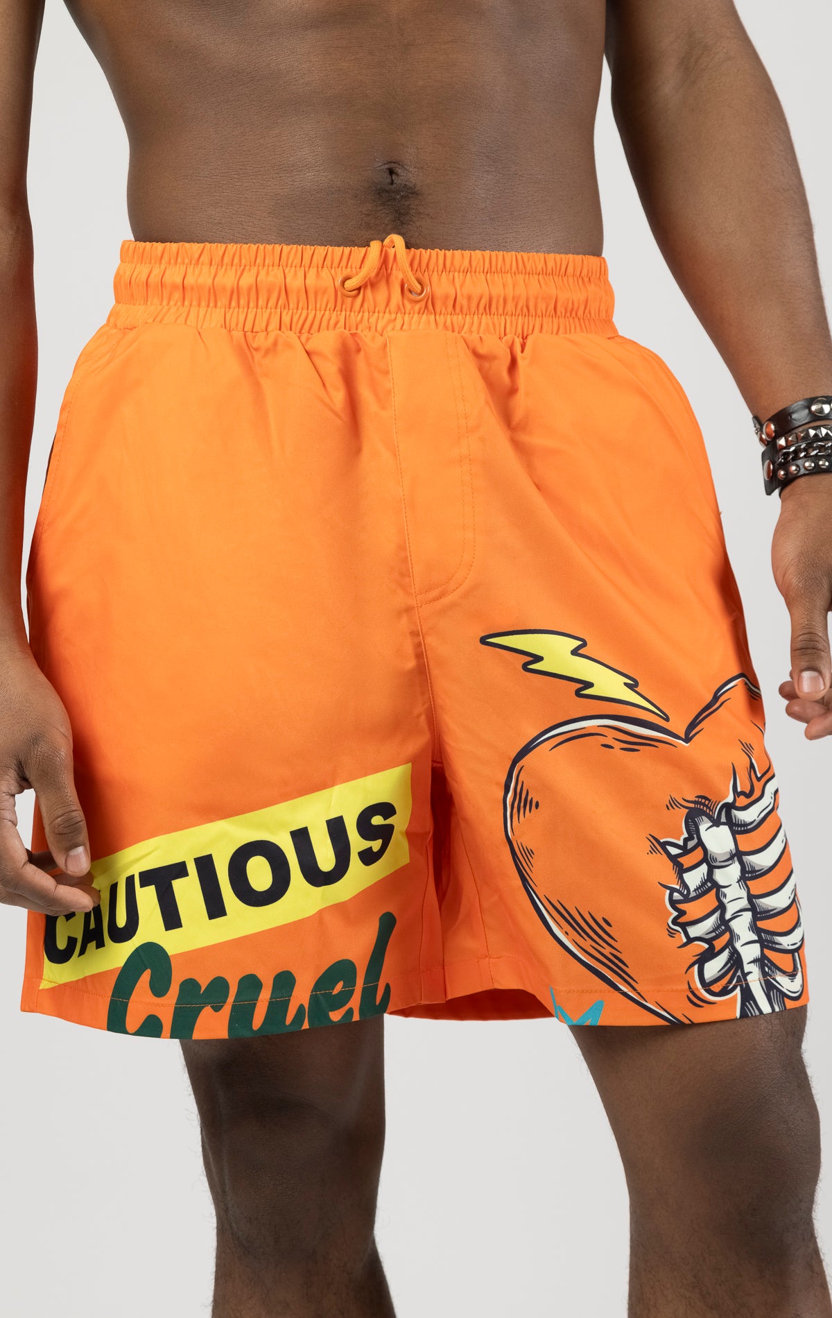 Orange board shorts with an elastic waist and graphic print