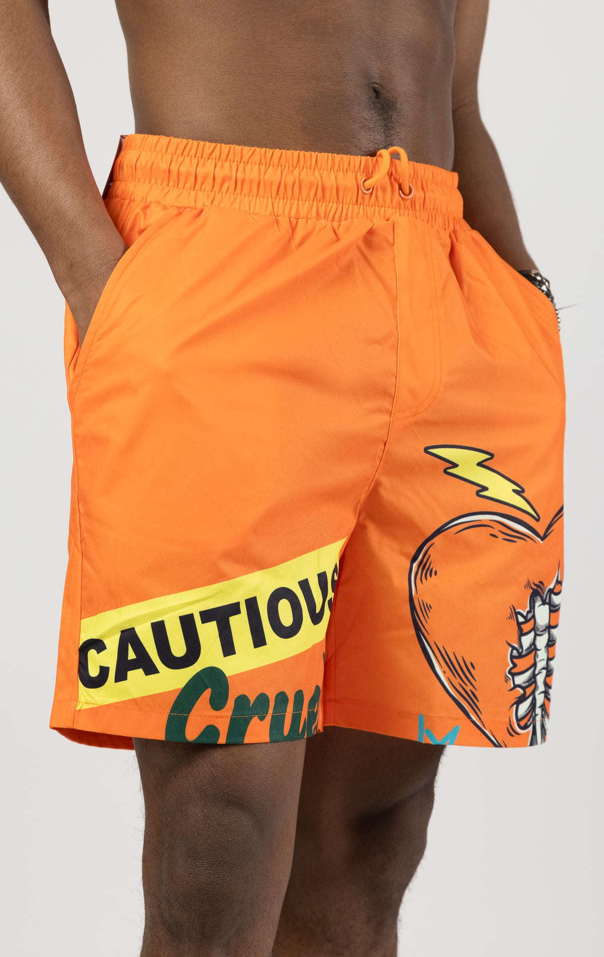 Orange board shorts with an elastic waist and graphic print