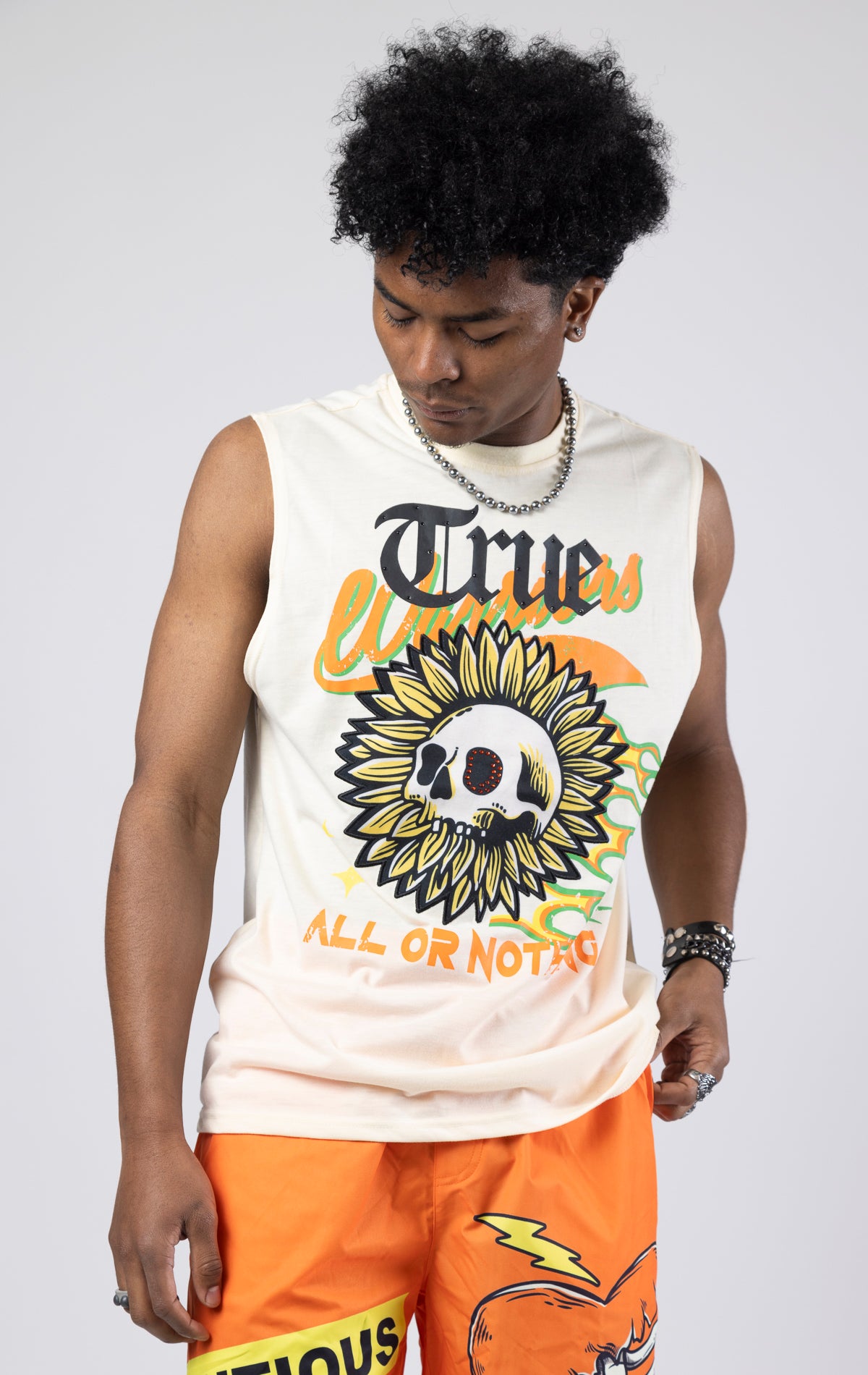 Creme Sleeveless crew neck tank top with a printed graphic.