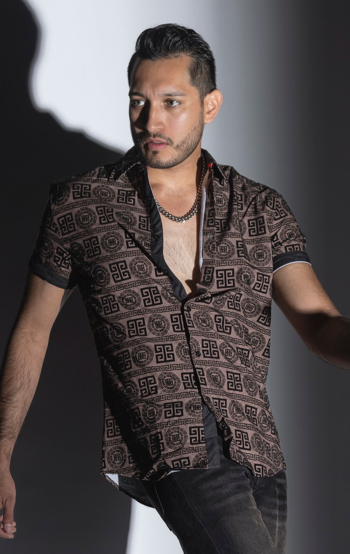 Men's casual, relaxed-fit button-down shirt with a short sleeve design. The shirt features an all-over Greek key pattern and a front button closure.