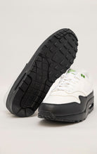 Green and white Nike Air Max 1 SE sneakers with a canvas upper, leather accents, and visible Air unit in the heel and forefoot