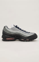 A black Nike Air Max 95 sneaker with a wavy mesh upper and visible Air cushioning units in the heel and forefoot. Anthracite and smoke grey accents contrast with pops of track red for a bold look.