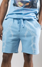 Sky blue fleece shorts with a digital lightning print running down the legs.