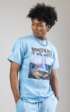 Sky blue t-shirt with a digital photo print on the front and back, embroidered text on the front, and a 3D metallic dagger embroidered on the back.