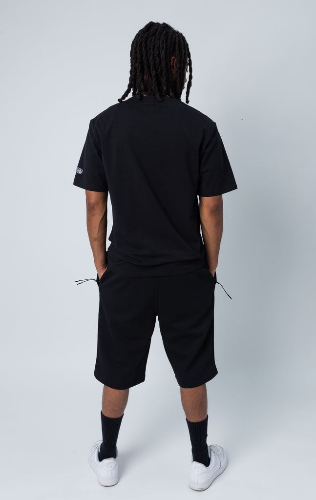Back side of black set of shirt and shorts with "LOVE" graphic.