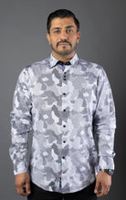 Man wearing a stylish shirt with contrasting patterns and sophisticated details, made from high-quality, performance stretch cotton fabric, perfect for both dressy and casual occasions.