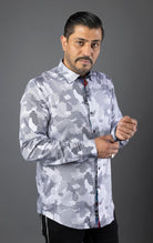 Man wearing a stylish shirt with contrasting patterns and sophisticated details, made from high-quality, performance stretch cotton fabric, perfect for both dressy and casual occasions.