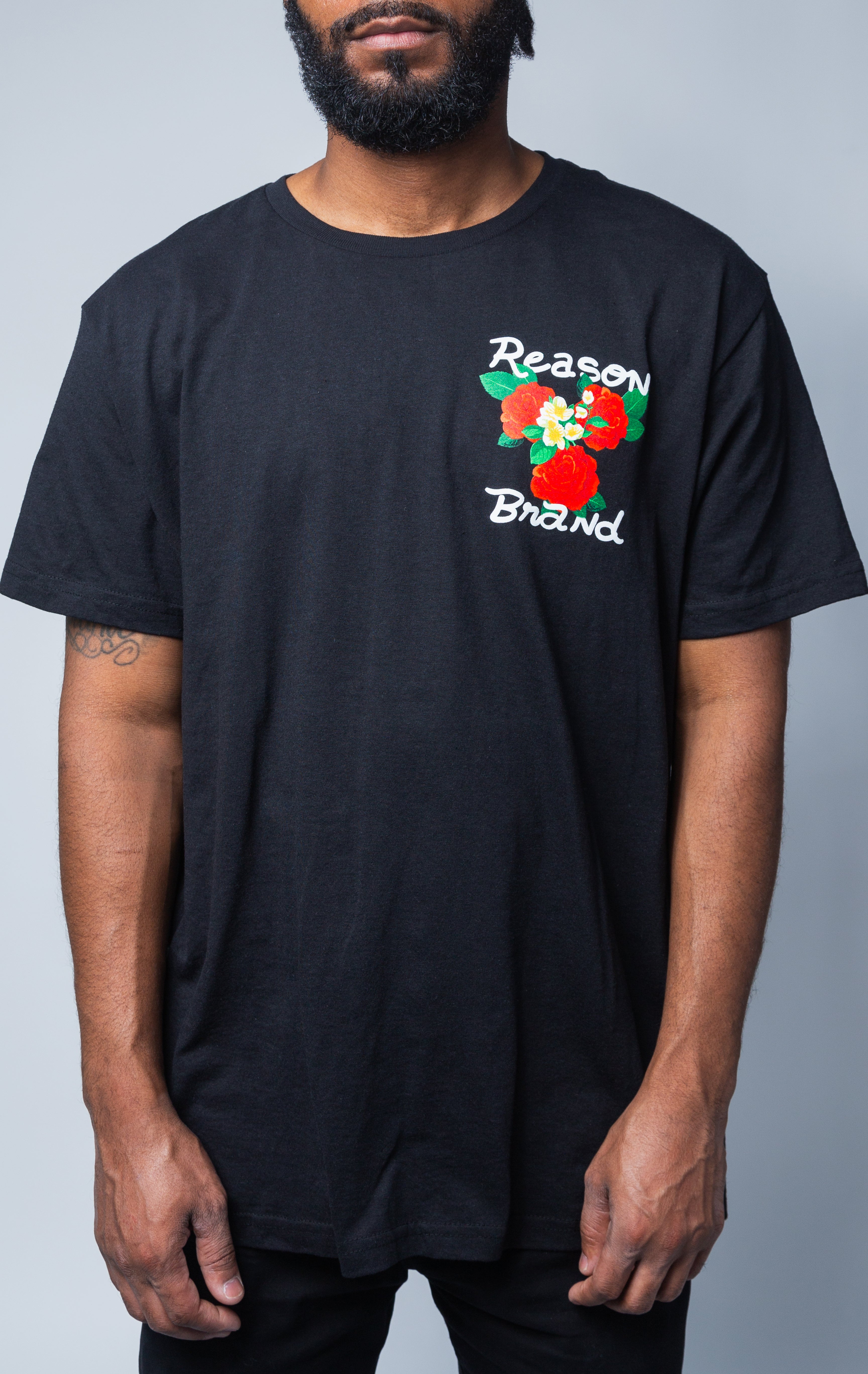 Reason Brand black t-shirt with roses graphic on top left 