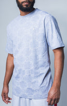 grey all-over tonal embossed pattern, short sleeve t-shirt with logo hardware on left side of chest