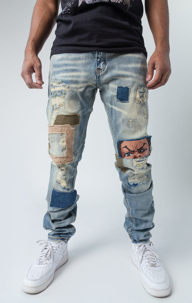 slim fit denim stretch pants, with indigo wash and rips. Features include Riley Face Knee HitInside, Huey & Riley Print Pockets, a Boondocks Logo Back Patch, a Huey Embroidered Silhouette, a Boondocks Metal Engraved Zipper, and a Boondocks Embroidered Logo within the Zipper Area.