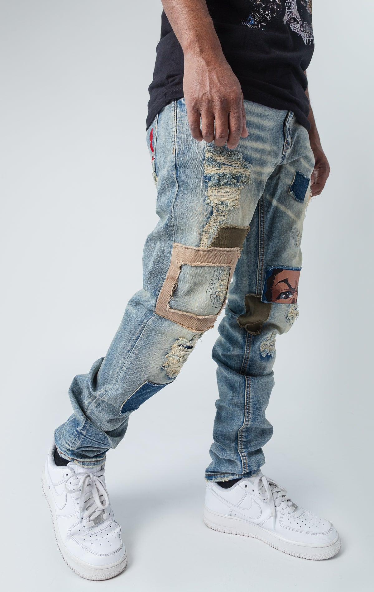 slim fit denim stretch pants, with indigo wash and rips. Features include Riley Face Knee HitInside, Huey & Riley Print Pockets, a Boondocks Logo Back Patch, a Huey Embroidered Silhouette, a Boondocks Metal Engraved Zipper, and a Boondocks Embroidered Logo within the Zipper Area.