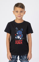 Kids Denim Lucky Charm Black t-shirt. Made from a comfortable blend of 95% cotton and 5% spandex. Features a denim fabric, crew neck, short sleeves, and a lucky charm patch.