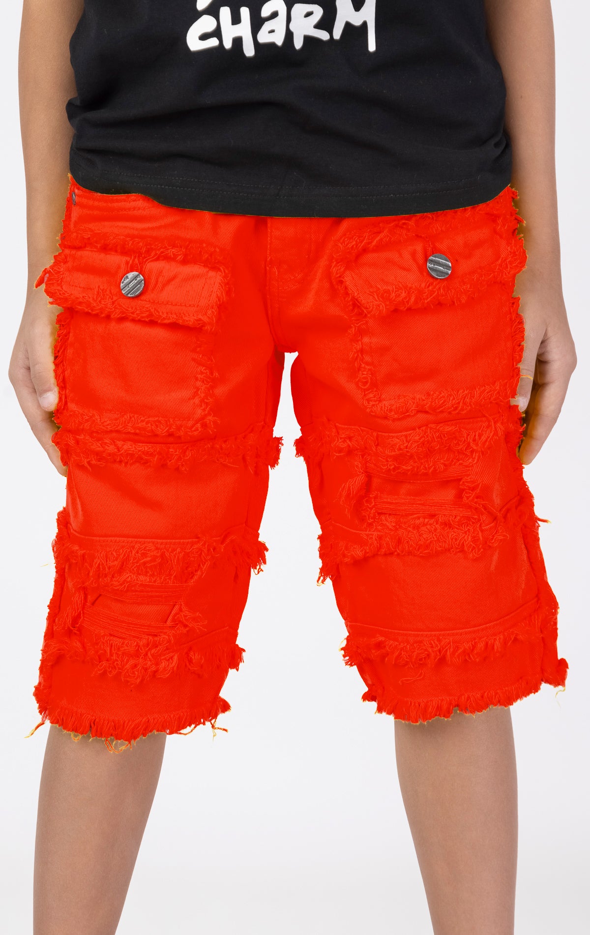 Kids Patchwork Layered Shorts in red. Features a playful patchwork design, two front pockets, and two back pockets. Designed for comfortable and active play.