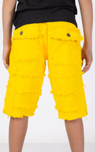 Kids Patchwork Layered Shorts in yellow. Features a playful patchwork design, two front pockets, and two back pockets. Designed for comfortable and active play.