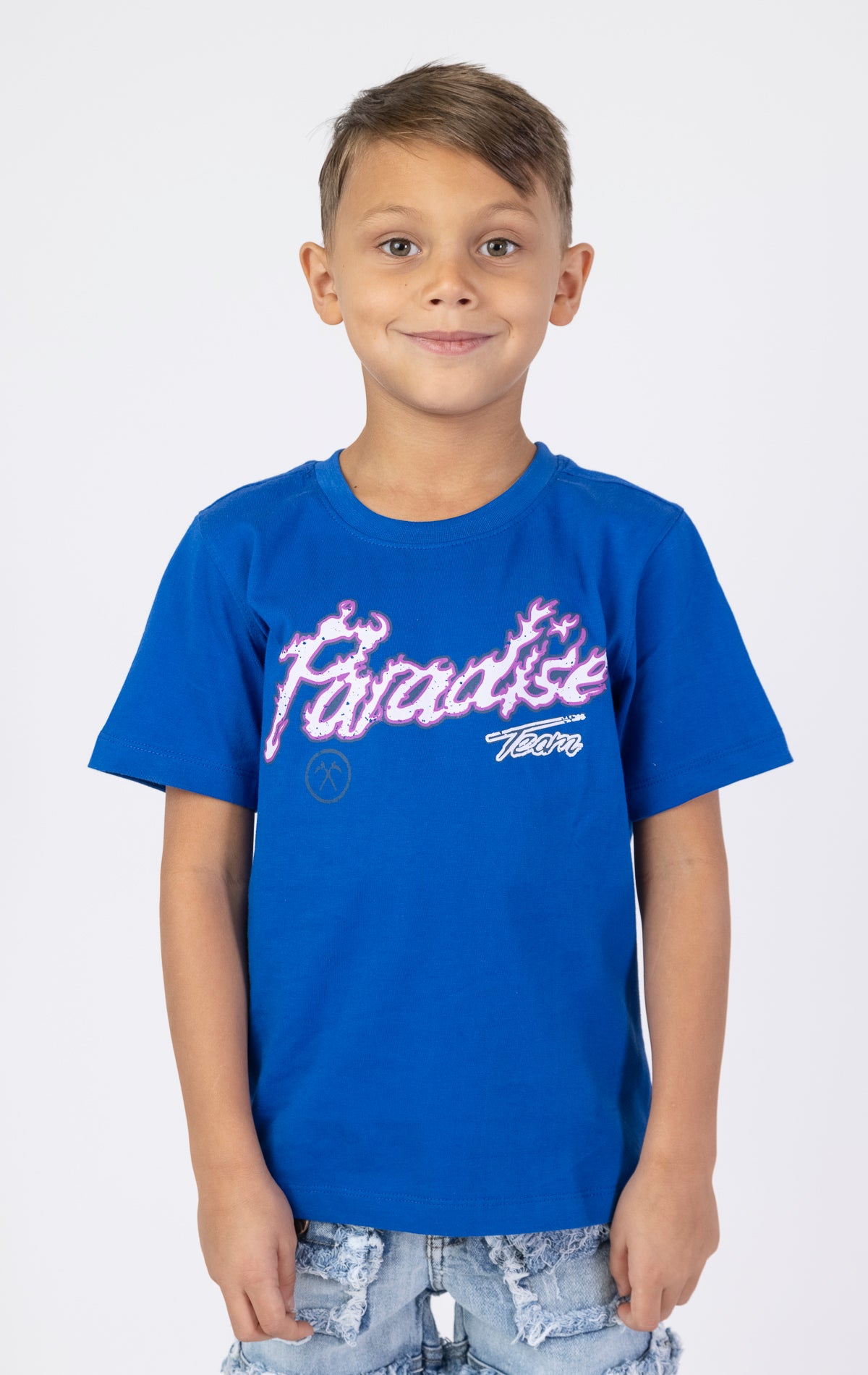 Kids Paradise Tour T-shirt. Features a classic crewneck, short sleeves, and screen-printed graphics on the front and back. Made from premium 220 GSM cotton for a soft and comfortable feel.