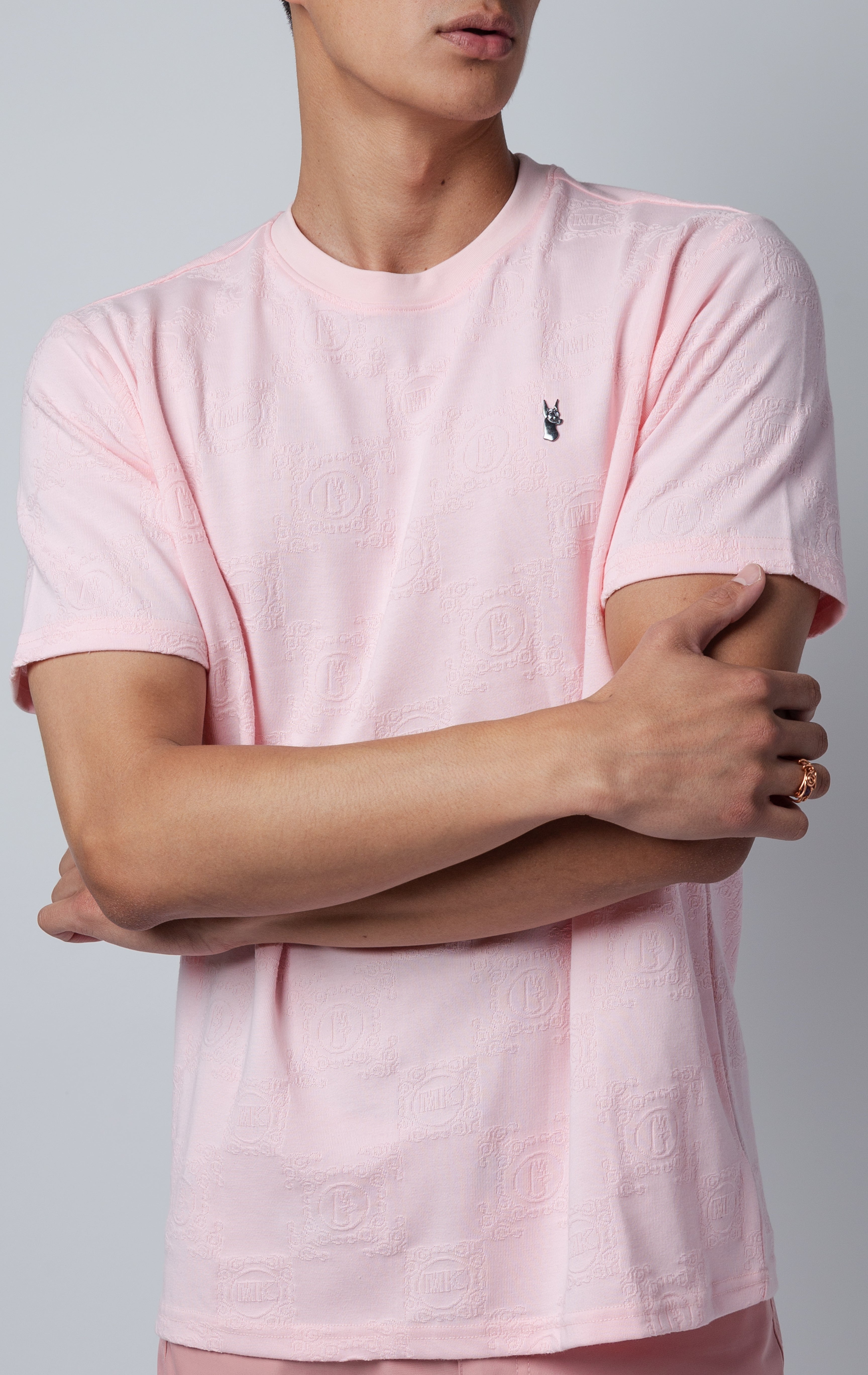 pink all-over tonal embossed pattern, short sleeve t-shirt with logo hardware on left side of chest