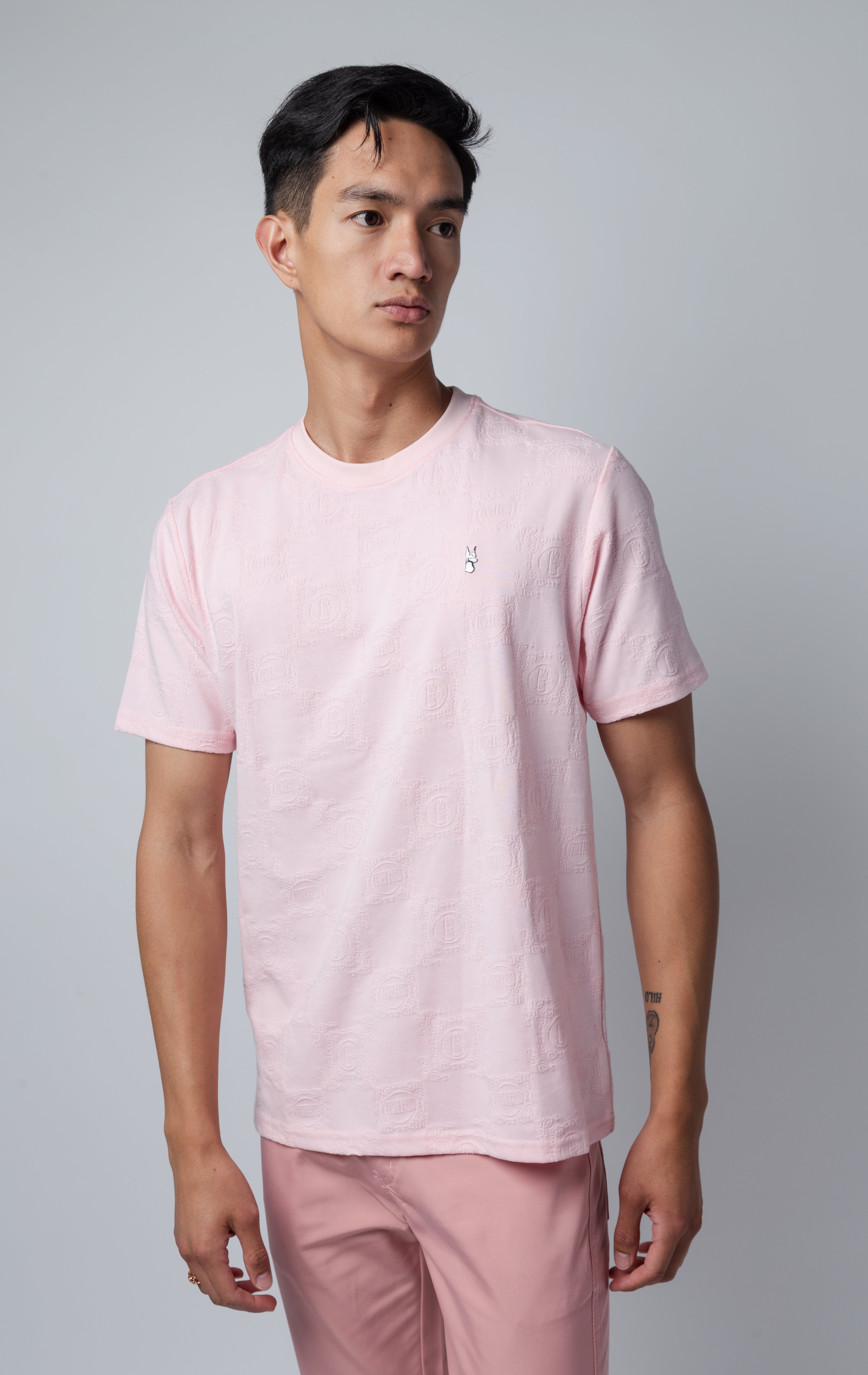 pink all-over tonal embossed pattern, short sleeve t-shirt with logo hardware on left side of chest