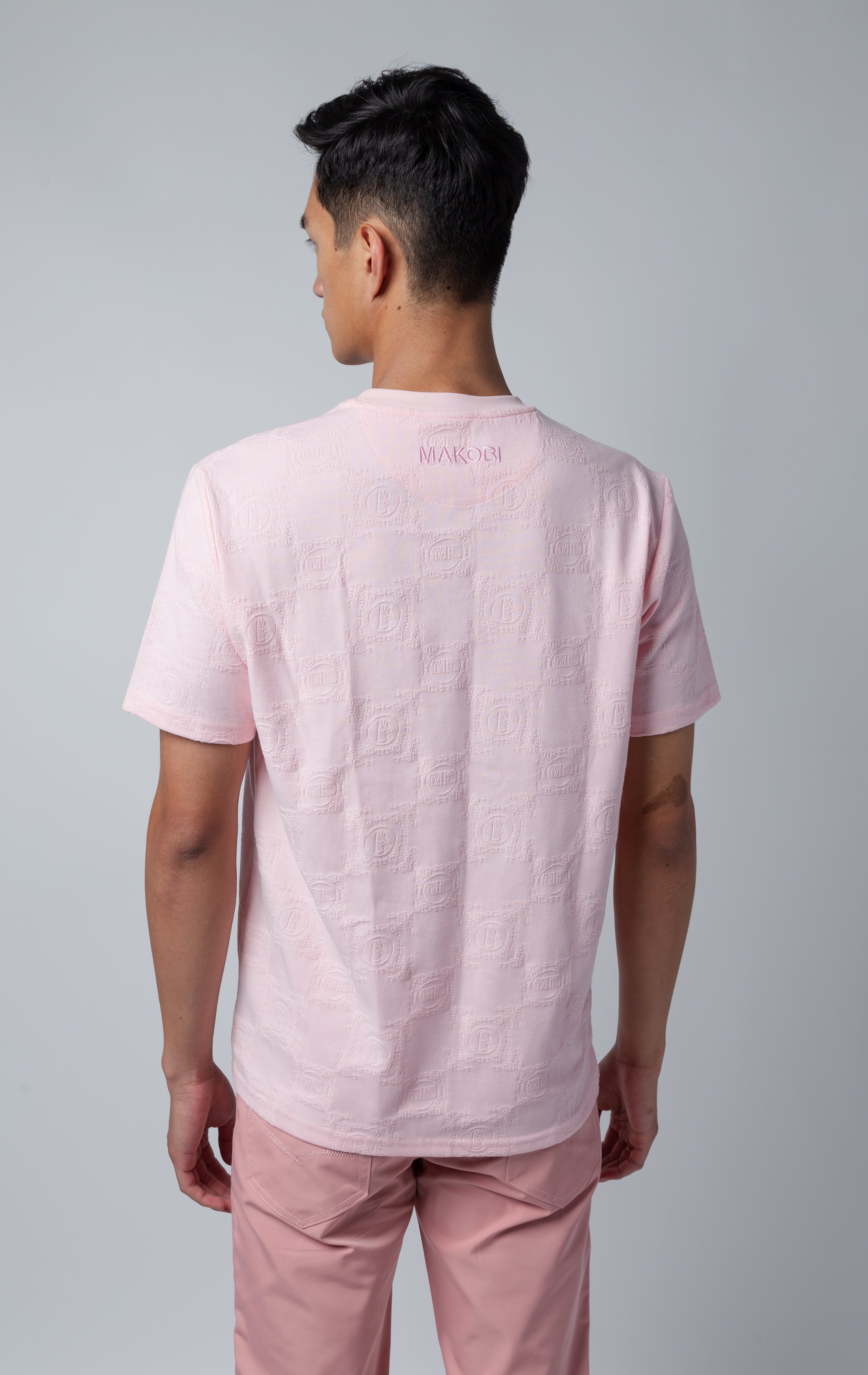 pink all-over tonal embossed pattern, short sleeve t-shirt with Makobi embroidery on upper back